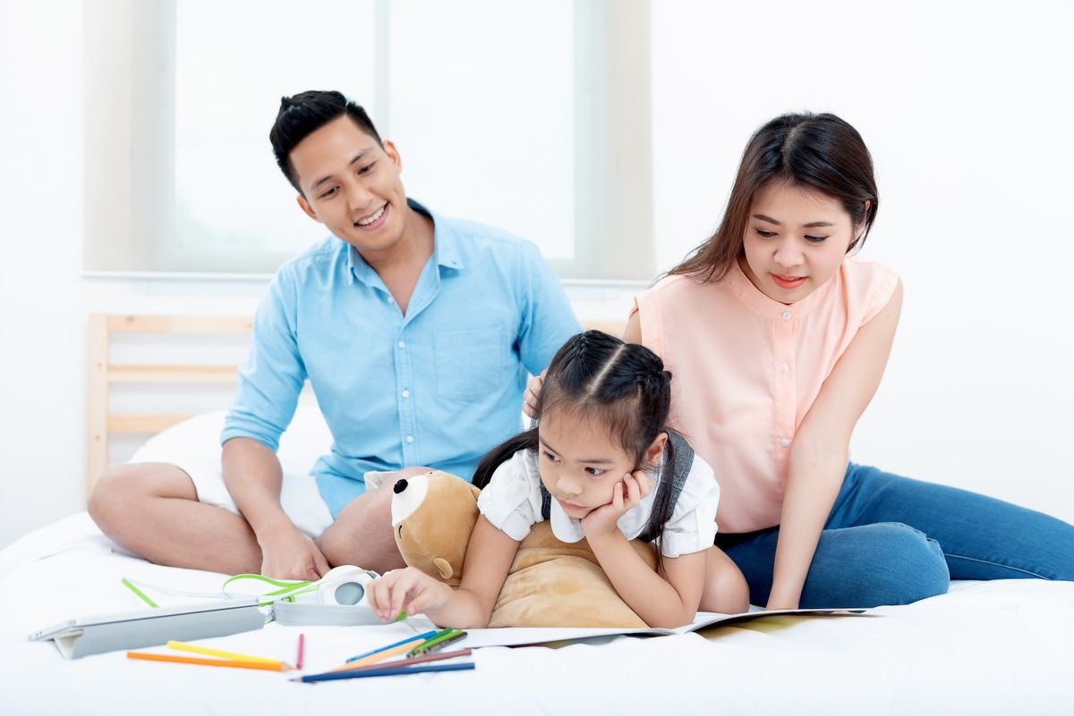 Asian people, Happy family in bedroom at home. Mother, Father and the children playing, Activities of family members are good family health of three people Education of kids, Health Insurance concept.